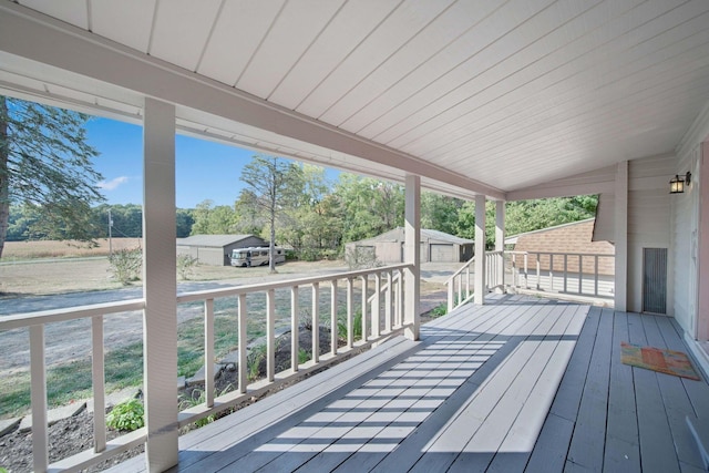 wooden deck featuring a shed