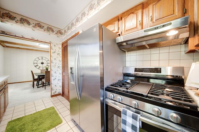 kitchen featuring decorative backsplash, light tile patterned floors, and appliances with stainless steel finishes