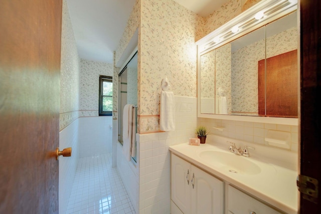 bathroom featuring vanity, tile patterned floors, and tile walls