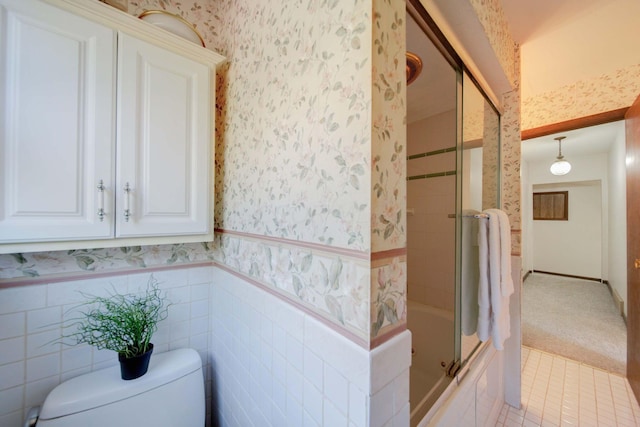 bathroom featuring shower / bath combination with glass door and toilet