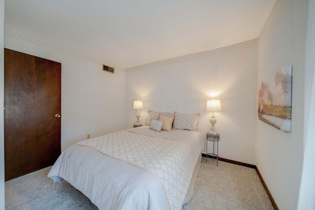 carpeted bedroom featuring ornamental molding