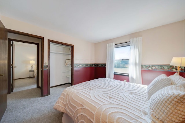 bedroom featuring light colored carpet and a closet