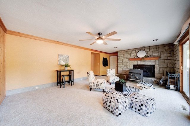 living room featuring a textured ceiling, carpet floors, and crown molding