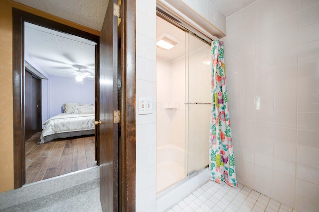 bathroom with hardwood / wood-style flooring, a shower with curtain, and ceiling fan