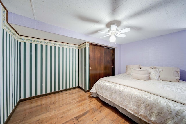 bedroom with wood-type flooring and ceiling fan