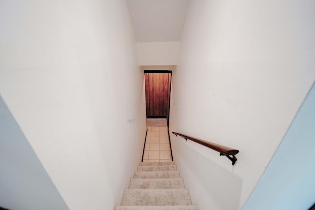 stairs with tile patterned floors