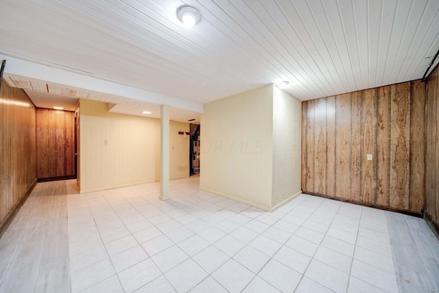 basement featuring wooden walls and wood ceiling