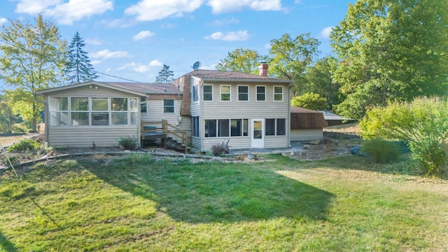 back of house with a sunroom and a yard