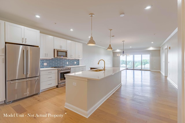 kitchen with a kitchen island with sink, light hardwood / wood-style flooring, white cabinets, and appliances with stainless steel finishes