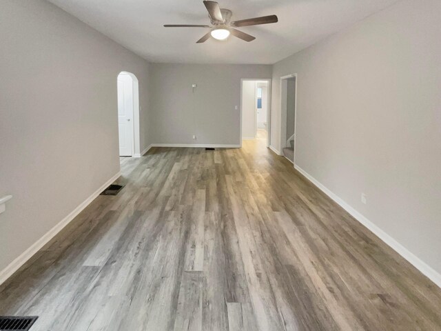 empty room featuring hardwood / wood-style flooring and ceiling fan