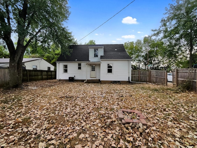 rear view of property featuring central AC