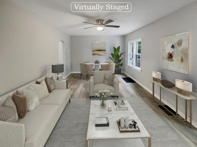 living room featuring ceiling fan and wood-type flooring