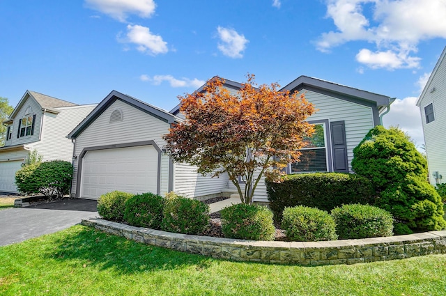 view of front of home featuring a front yard and a garage