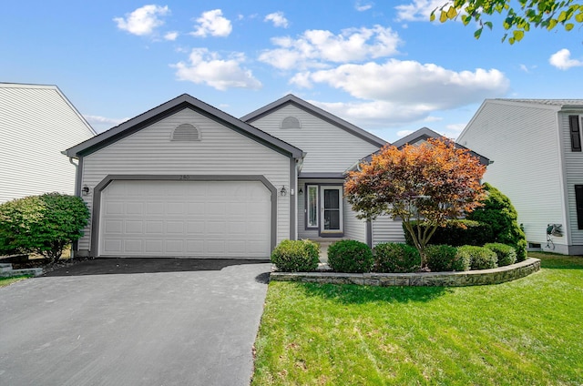 view of front of house with a garage and a front yard