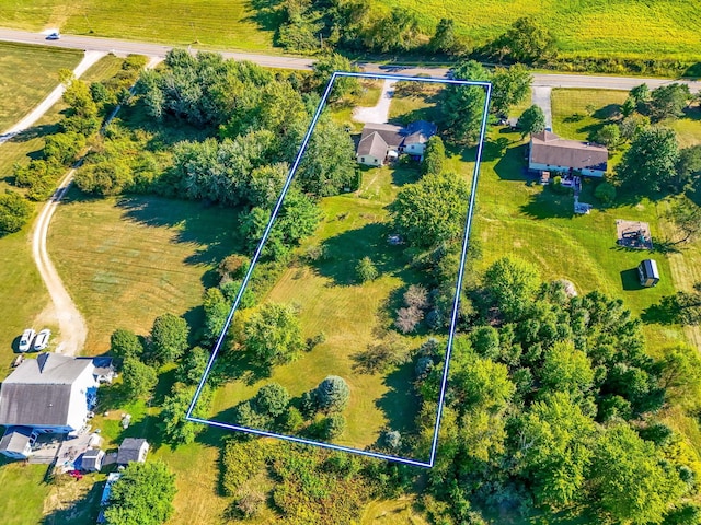 birds eye view of property with a rural view