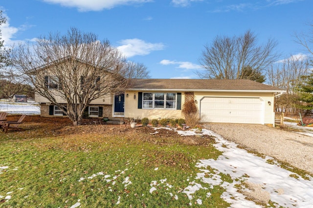 view of front of property featuring a garage and a front lawn