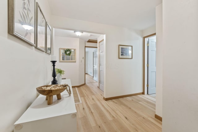 hallway with light hardwood / wood-style flooring