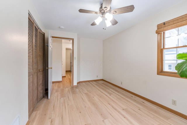 unfurnished bedroom with ceiling fan and light hardwood / wood-style flooring