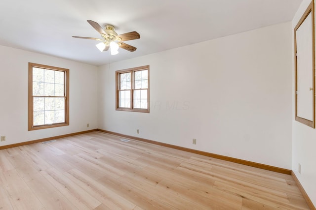 unfurnished room with plenty of natural light, ceiling fan, and light hardwood / wood-style flooring