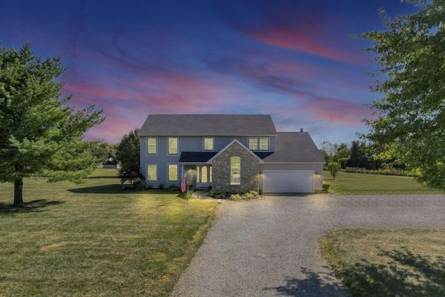 view of front facade with a lawn and a garage