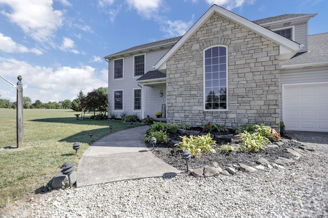 view of front facade with a front yard and a garage