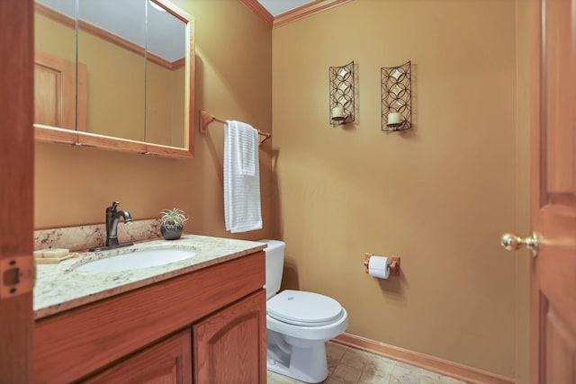 bathroom featuring vanity, toilet, and crown molding