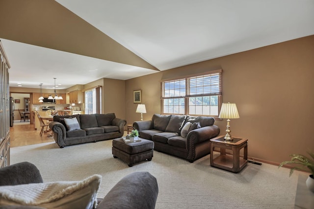 living room featuring light colored carpet and vaulted ceiling