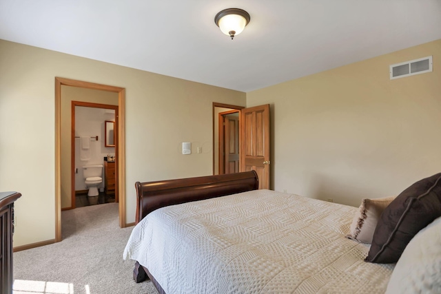 carpeted bedroom featuring connected bathroom