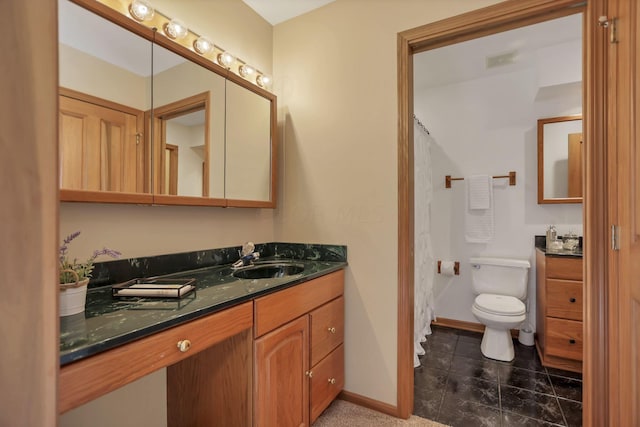 bathroom featuring tile patterned floors, vanity, and toilet