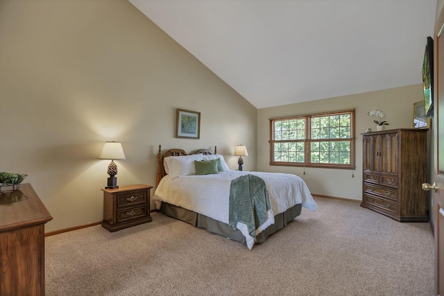 bedroom featuring light carpet and high vaulted ceiling