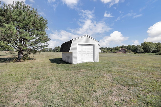 view of outdoor structure featuring a lawn and a rural view