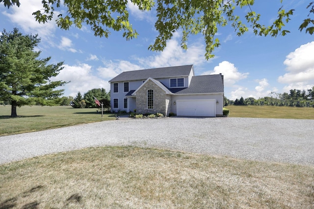 view of front of property featuring a garage and a front lawn