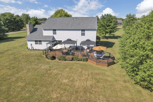 rear view of house featuring a gazebo, a yard, and a deck