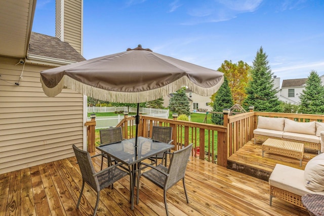 deck with an outdoor hangout area and a lawn