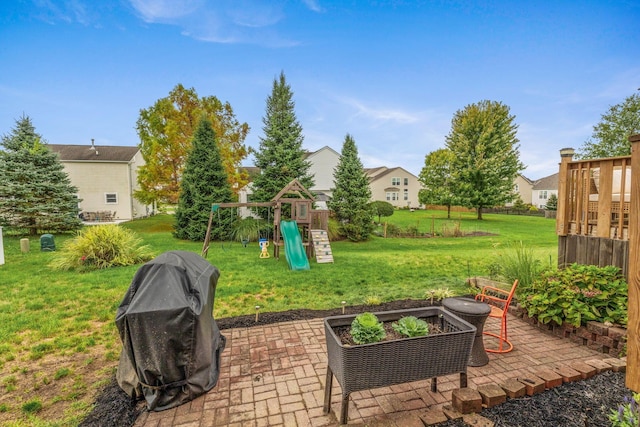 view of patio featuring grilling area and a playground