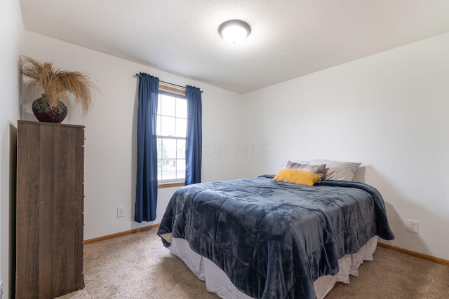 carpeted bedroom with a textured ceiling