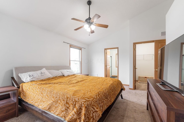 carpeted bedroom featuring a spacious closet, vaulted ceiling, a closet, and ceiling fan