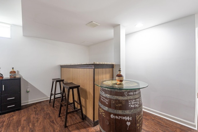 bar featuring dark wood-type flooring