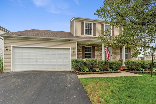 view of front property featuring a garage and a front lawn