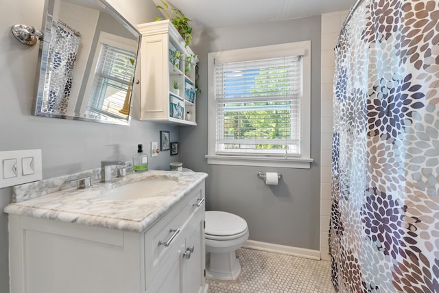 bathroom featuring tile patterned floors, vanity, toilet, and walk in shower