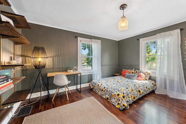 bedroom with dark hardwood / wood-style floors and crown molding