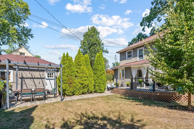 view of yard featuring a pergola and a wooden deck