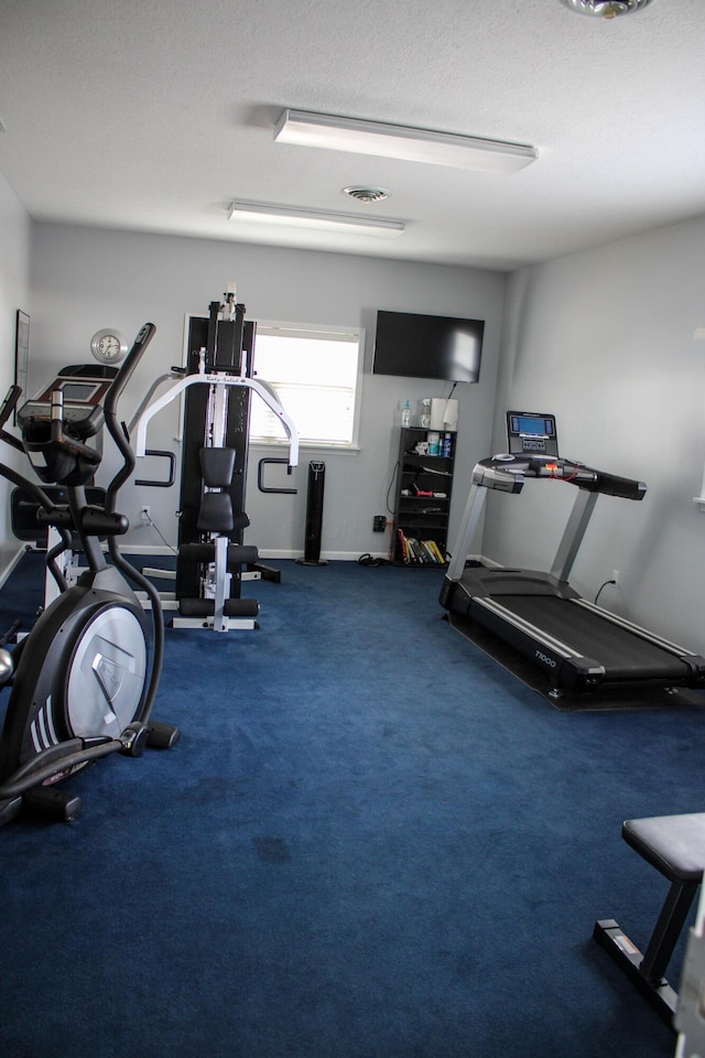 workout room with a textured ceiling