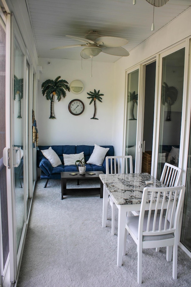 sunroom featuring ceiling fan