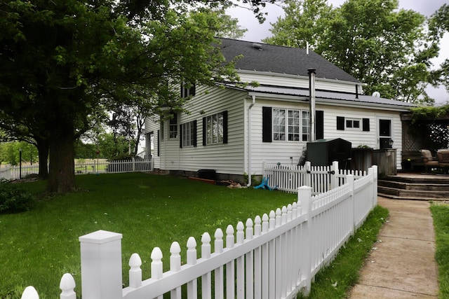 view of front of home featuring a front yard and a deck