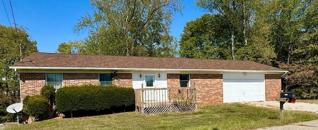 ranch-style home with a garage, a front lawn, and a deck