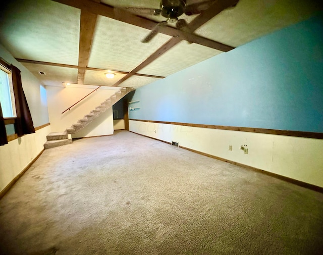 additional living space featuring beam ceiling, carpet floors, and ceiling fan