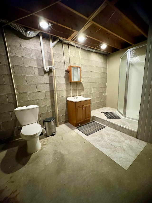 bathroom featuring vanity, toilet, a shower with door, and concrete flooring