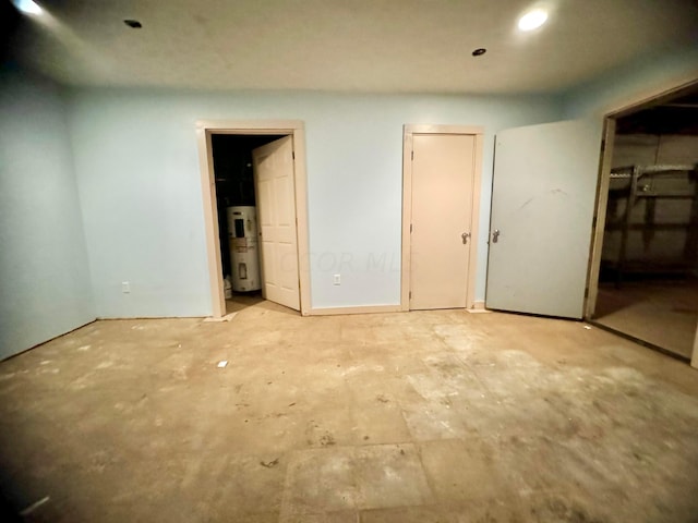 unfurnished bedroom with connected bathroom and water heater