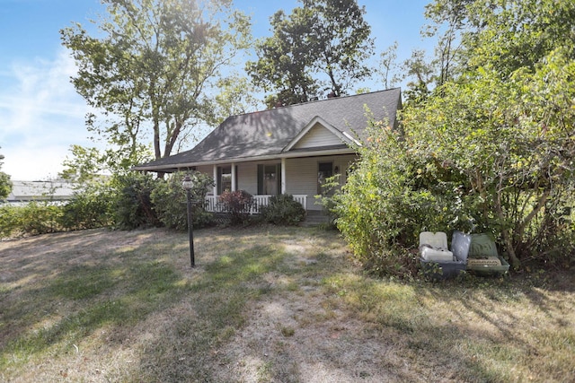 view of front of house with a porch and a front yard